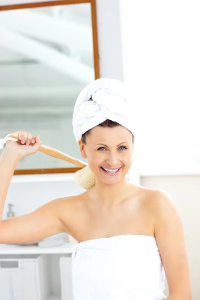 Tętniącej życiem kobiety mycie jej plecy, uśmiechając się do kamery — Zdjęcie stockowe