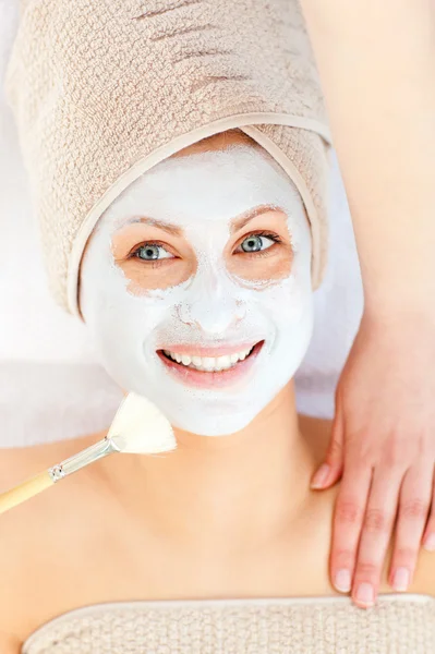 Radiant young woman having white cream on her face — Stock Photo, Image