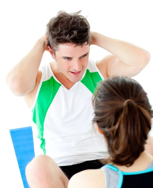 Handsome man doing fitness exercises with a woman — Stock Photo, Image