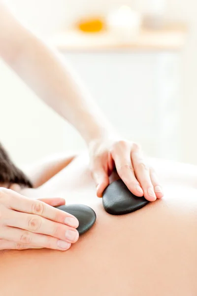 Close-up of a young man receiving a massage with hot stone — Stock Photo, Image