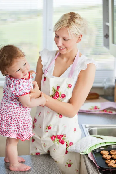 Beautiful mother baking with her daughter together — Stock Photo, Image