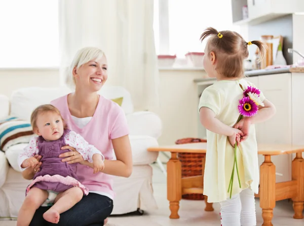 Delighted mother get surprise by her daughters — Stock Photo, Image