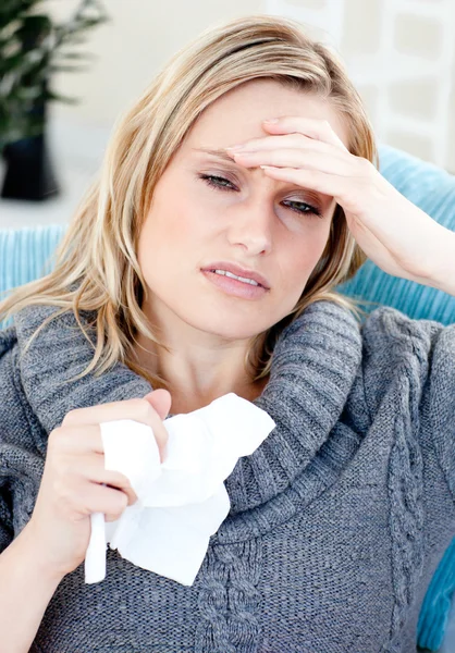 Caucasian woman with headache and tissues at home — Stock Photo, Image