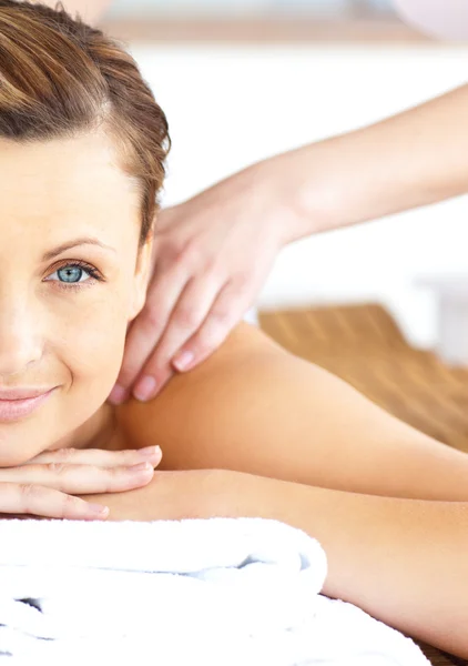 Primer plano de una hermosa mujer recibiendo un masaje de espalda mirando un — Foto de Stock