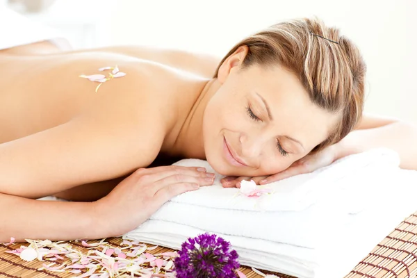 Beautiful relaxed woman lying on a massage table — Stock Photo, Image