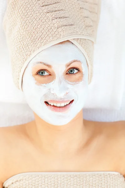 Radiant young woman having white cream on her face — Stock Photo, Image