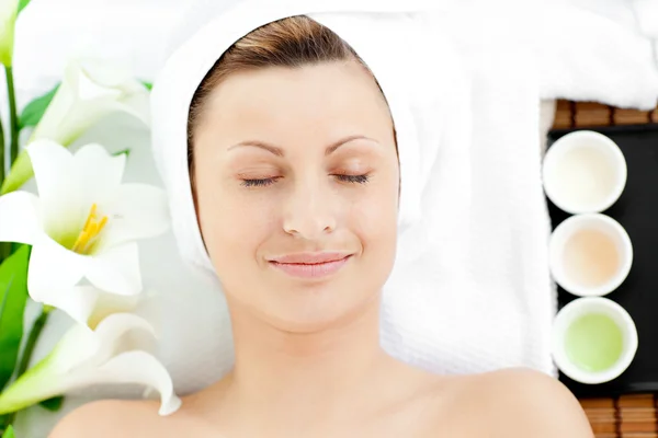 Happy young woman resting on a massage table — Stock Photo, Image