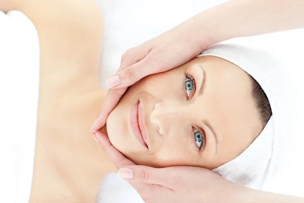 Charming young woman enjoying a facial massage — Stock Photo, Image