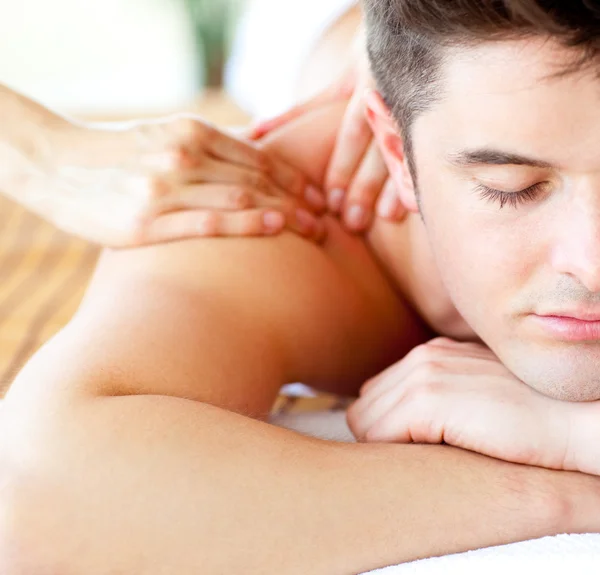 Close-up of an attractive man having a back massage