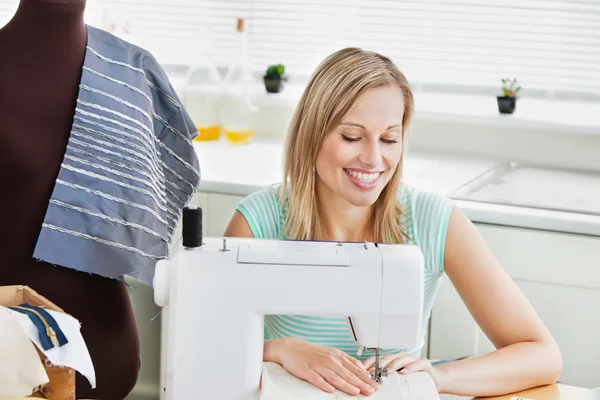 Radiant woman sewing clothes at home — Stock Photo, Image