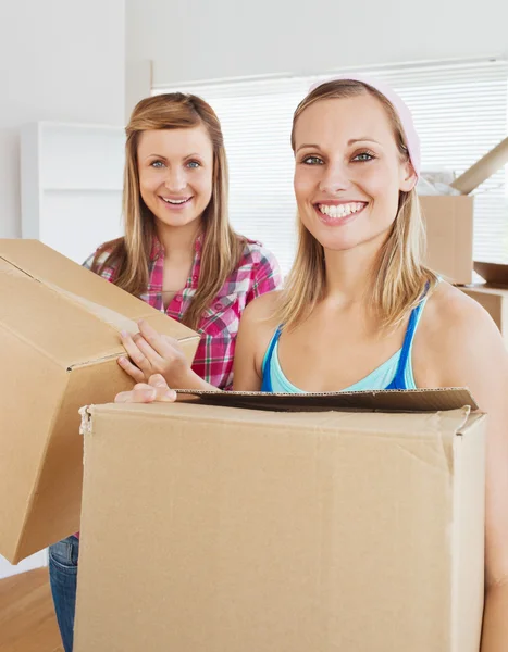 Charming friends holding boxes — Stock Photo, Image