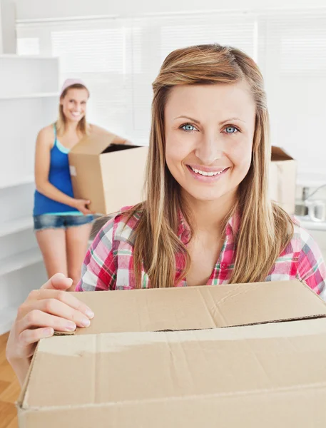 Delighted woman holding boxes after moving — Stock Photo, Image