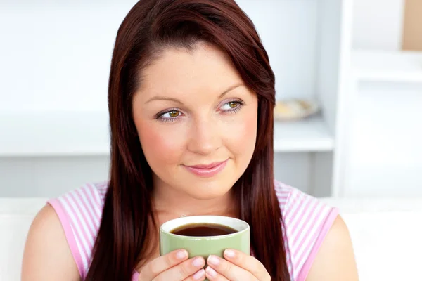 Caucasian woman holding a cup of coffee at home — Stock Photo, Image