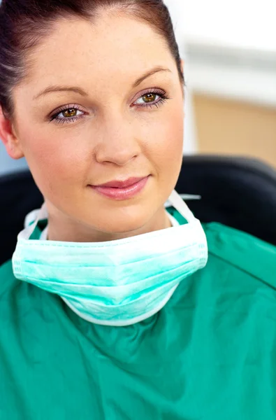 Beautiful female doctor with scrubs sitting in her office — Stock Photo, Image