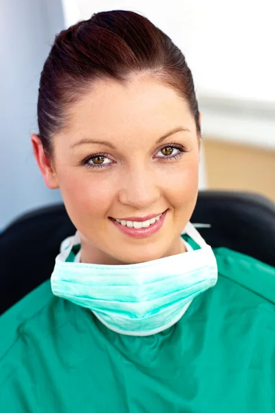 Assertive female doctor with scrubs sitting in her office — Stock Photo, Image