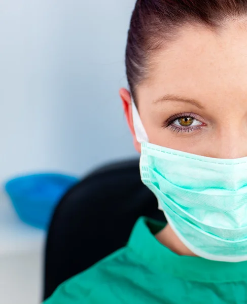 Close-up of a beautiful female doctor with scrubs sitting in her — Stock Photo, Image