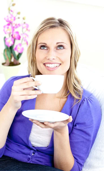 Světlé žena užívat kávu sedět na pohovce — Stock fotografie