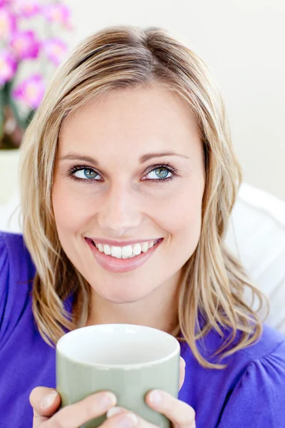 Portrait of a caucasian blond woman enjoying her coffee sitting — Stock Photo, Image