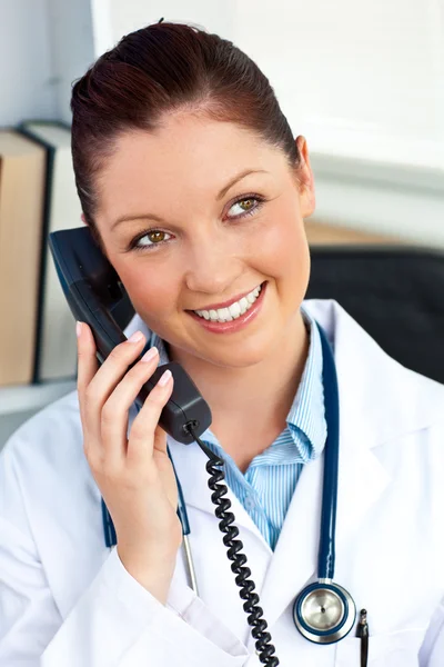 Delighted female doctor talking on phone — Stock Photo, Image