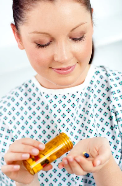 Glowing patient holding pills — Stock Photo, Image