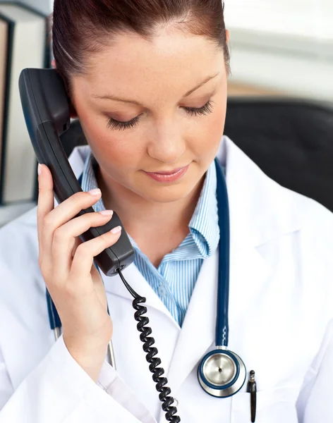 Portrait of a serious female doctor phoning in her office — Stock Photo, Image
