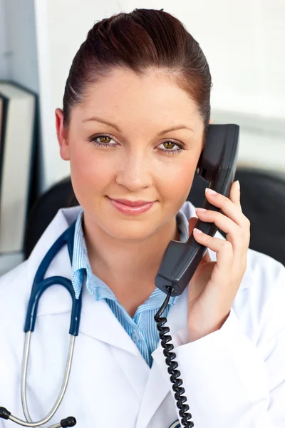 Portrait of an assertive female doctor phoning in her office — Stock Photo, Image