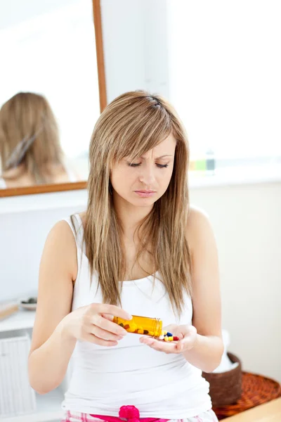 Mulher doente tomando pílulas em seu banheiro — Fotografia de Stock