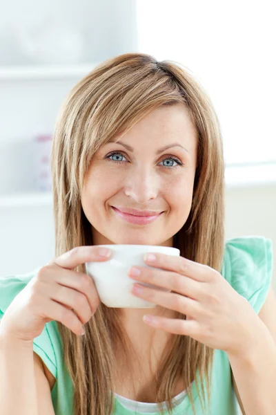 Bright woman holding a cup of coffee in the kitchen — Stock Photo, Image