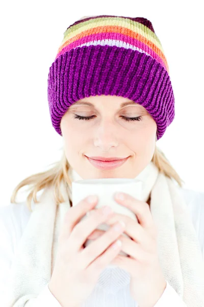 Delighted woman with a colorful hat and a cup in her hands — Stock Photo, Image