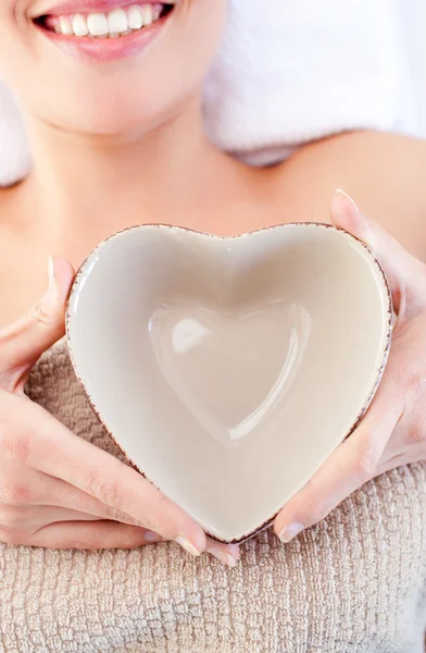 Close-up of a woman holding a bowl in the shape of a heart — Stock Photo, Image