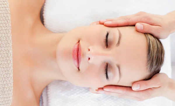 Jovem mulher relaxada recebendo uma massagem na cabeça — Fotografia de Stock