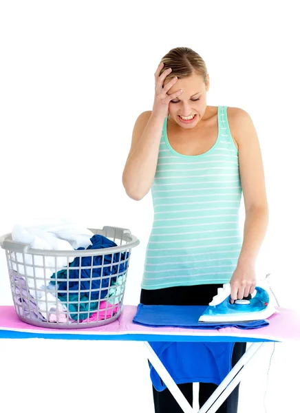 Frustrated woman ironing her clothes — Stock Photo, Image