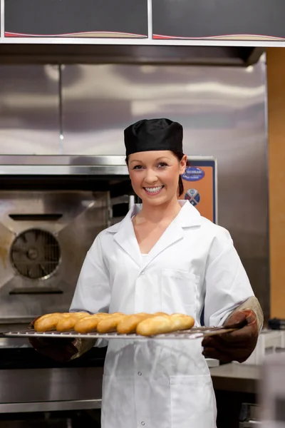 Lachende jonge bakker met stokbrood — Stockfoto