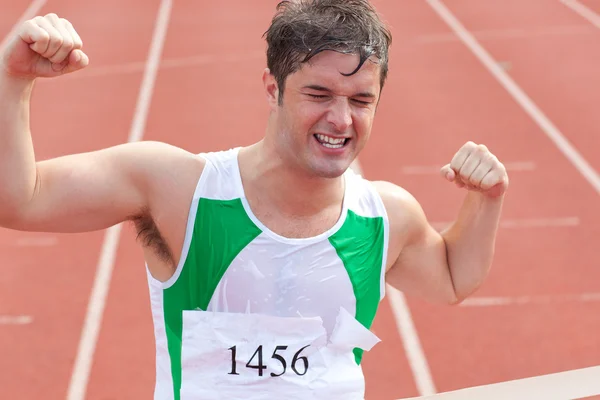 Ecstatic sprinter showing expression of victory in front of the — Stock Photo, Image