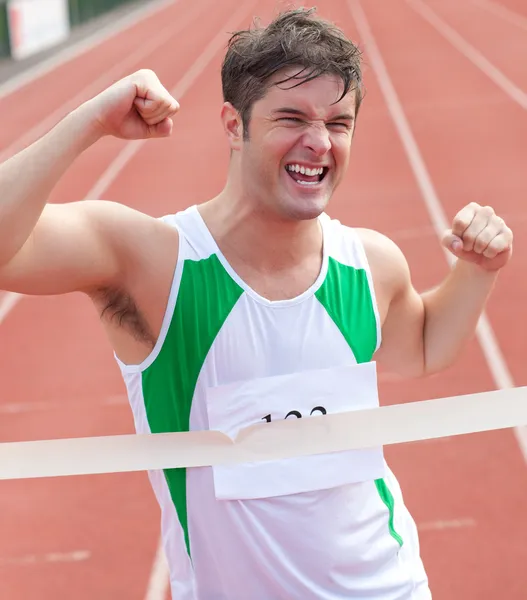 Exulting sprinter showing expression of victory in front of the — Stock Photo, Image