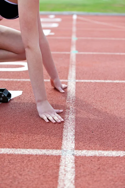 Close-up of a woman waiting in starting block — Stock Photo, Image