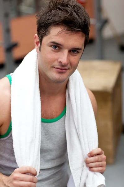 Handsome athletic man standing with a towel — Stock Photo, Image
