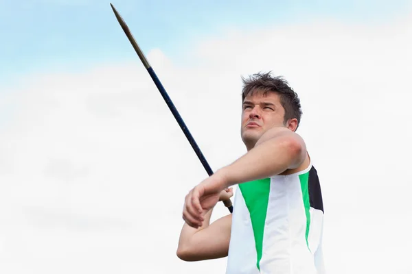 Determined sportsman throwing the javelin — Stock Photo, Image