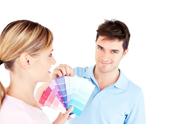Bright young couple choosing color for a room — Stock Photo, Image