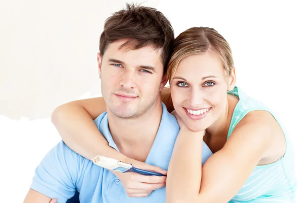 Portrait of a young enamored couple painting their new room — Stock Photo, Image