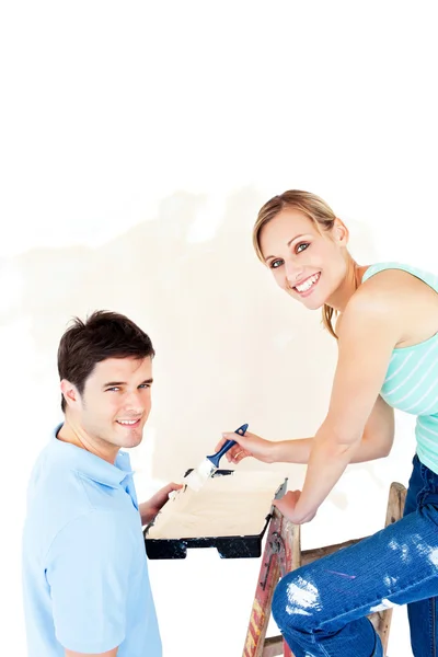 Attractive caucasian couple painting a room — Stock Photo, Image