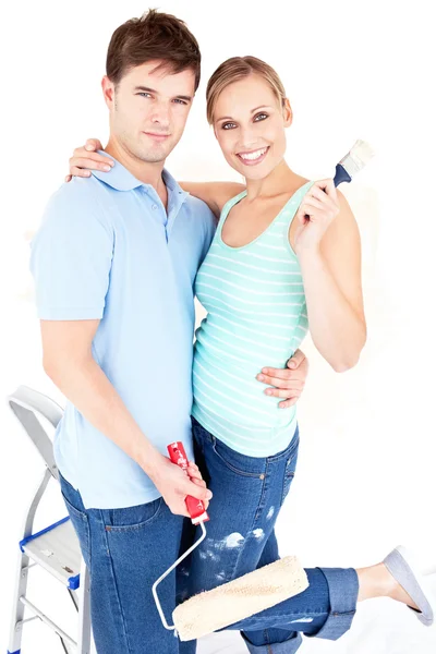 Loving caucasian couple painting a room — Stock Photo, Image