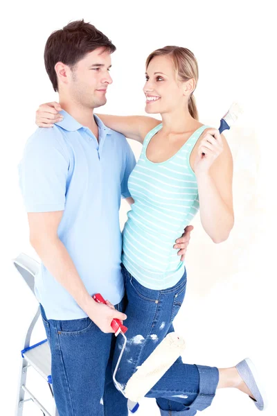 Affectionate young couple painting a room — Stock Photo, Image