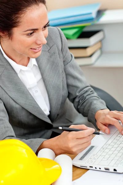 Concentrated female architect studying a project at work in her — Stock Photo, Image
