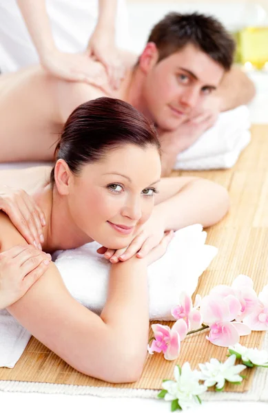 Merry young couple enjoying a back massage — Stockfoto