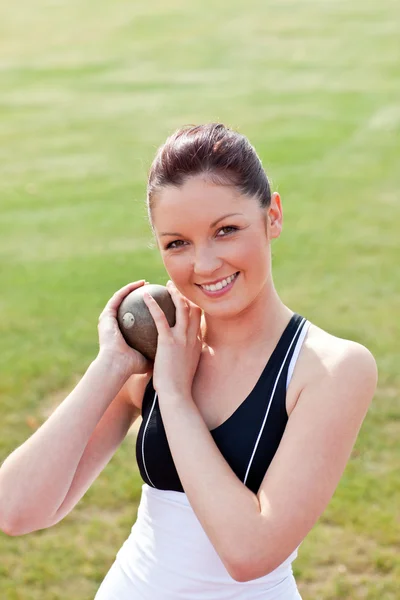 Attractive female athlete holding weight — Stock Photo, Image