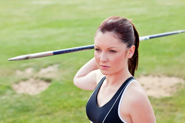stock image Determined female athlete ready to throw javelin