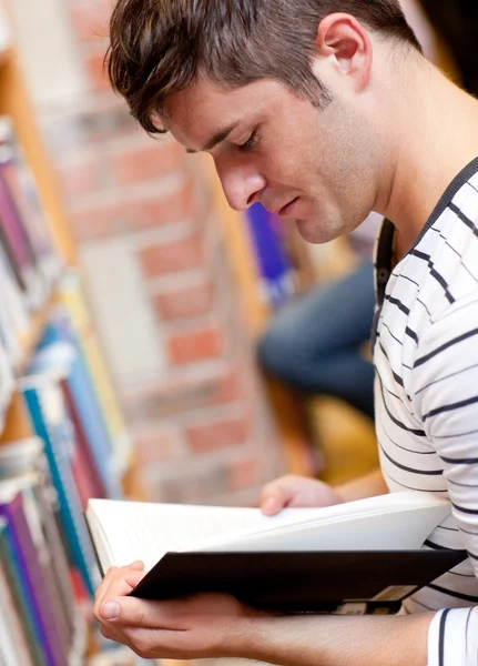 Serious young man reading a book — Stock Photo, Image