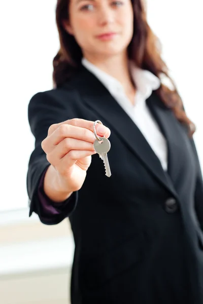 Portrait of an assertive businesswoman holding a key — Stock Photo, Image