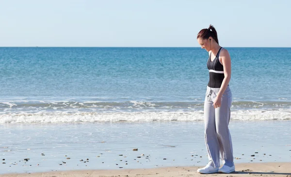 उज्ज्वल महिला समुद्र तट पर खड़े और संगीत सुनते हुए — स्टॉक फ़ोटो, इमेज